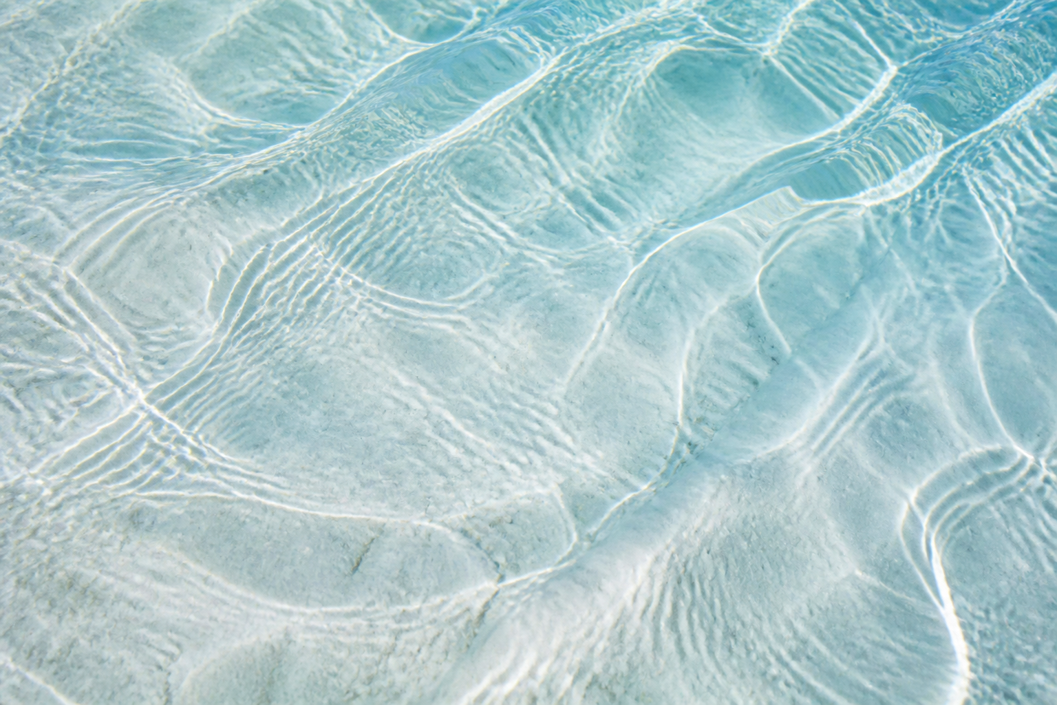 Light moving over clear water
