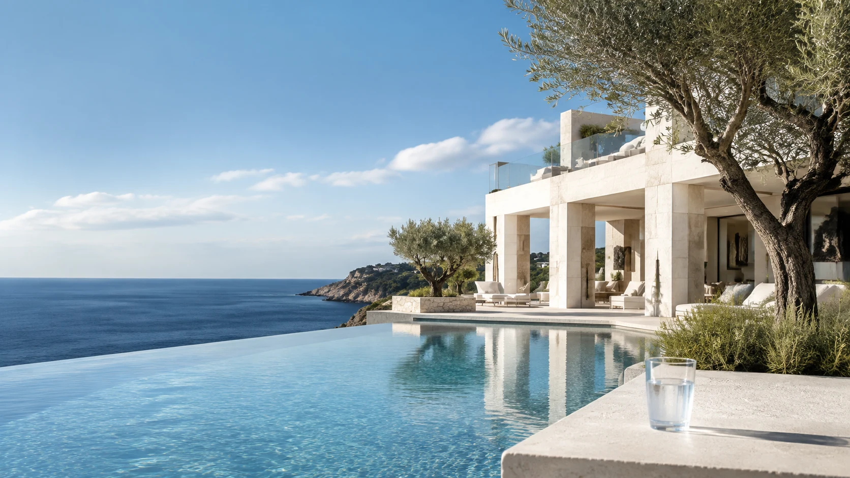 Contemporary Mediterranean villa in Spain with an infinity pool, sea view and a glass of water.